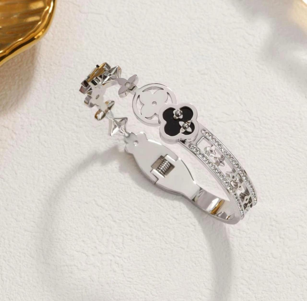 Titanium Silver bangle featuring black clover motifs and crystal accents