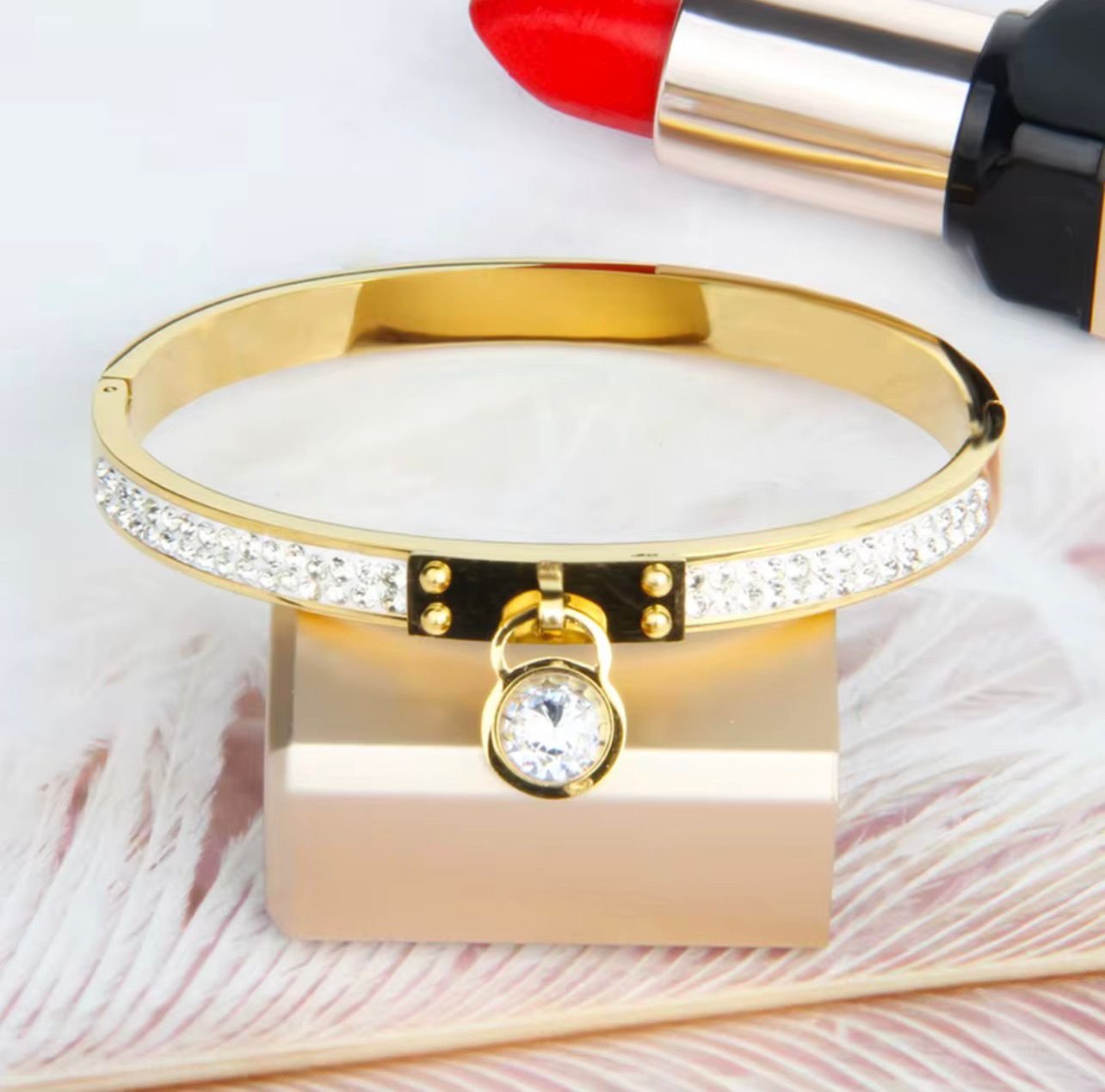 18K Gold-Plated meticulously paved with two rows of sparkling cubic zircon stones and a dangling round