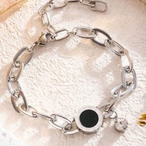 Titanium bracelet featuring round charm with black inlay and Roman numerals, and a dangling zircon stone