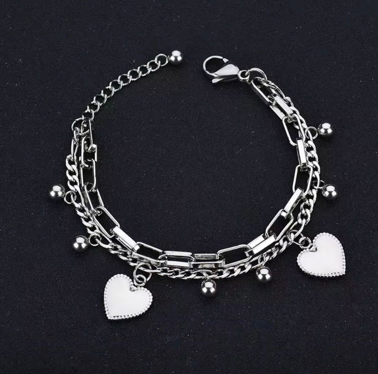 Titanium silver double-chain bracelet featuring heart charms and small ball beads