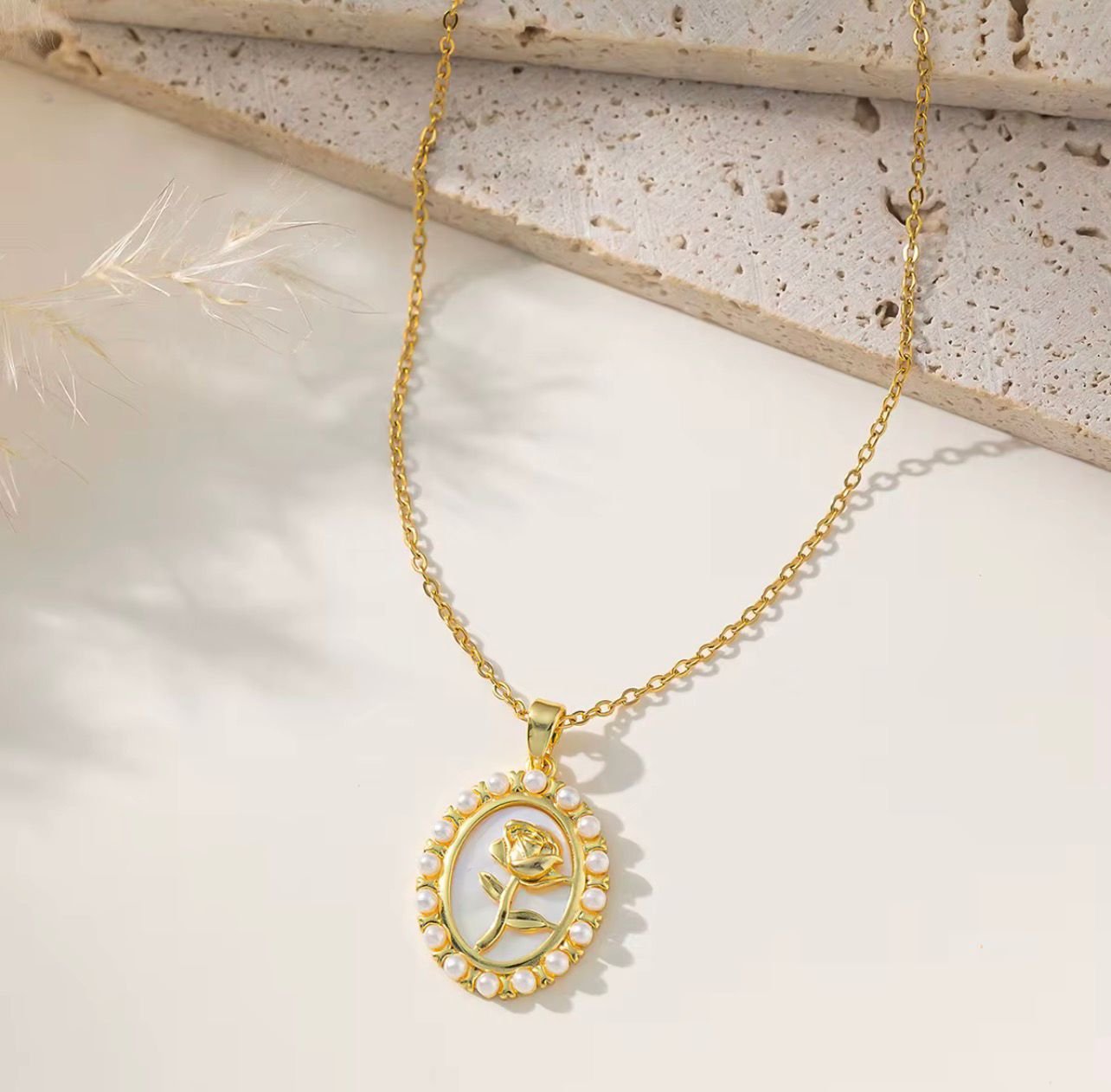 18K Gold-Plated necklace with a rose design enclosed in an oval border decorated with small pearls