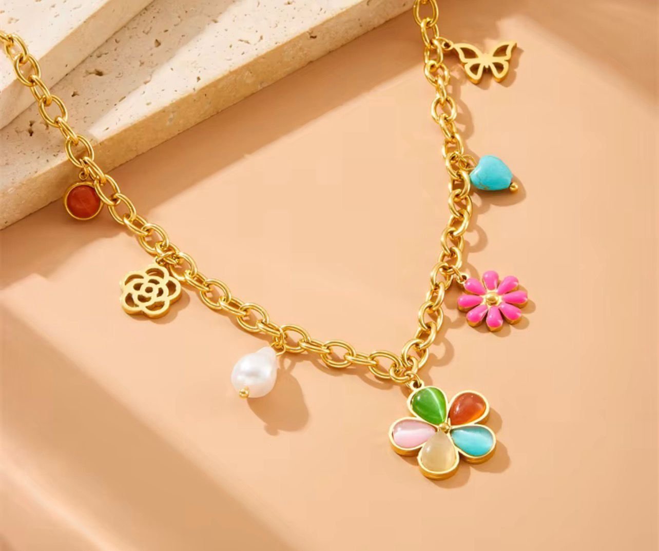 18K Gold-Plated colorful charm necklace featuring a mix of pendants, including a flower, butterfly, and pearl