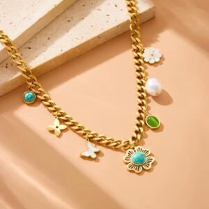 18K Gold-Plated trendy necklace featuring a chunky chain and various charms including a turquoise flower, pearl, butterfly, and green stone