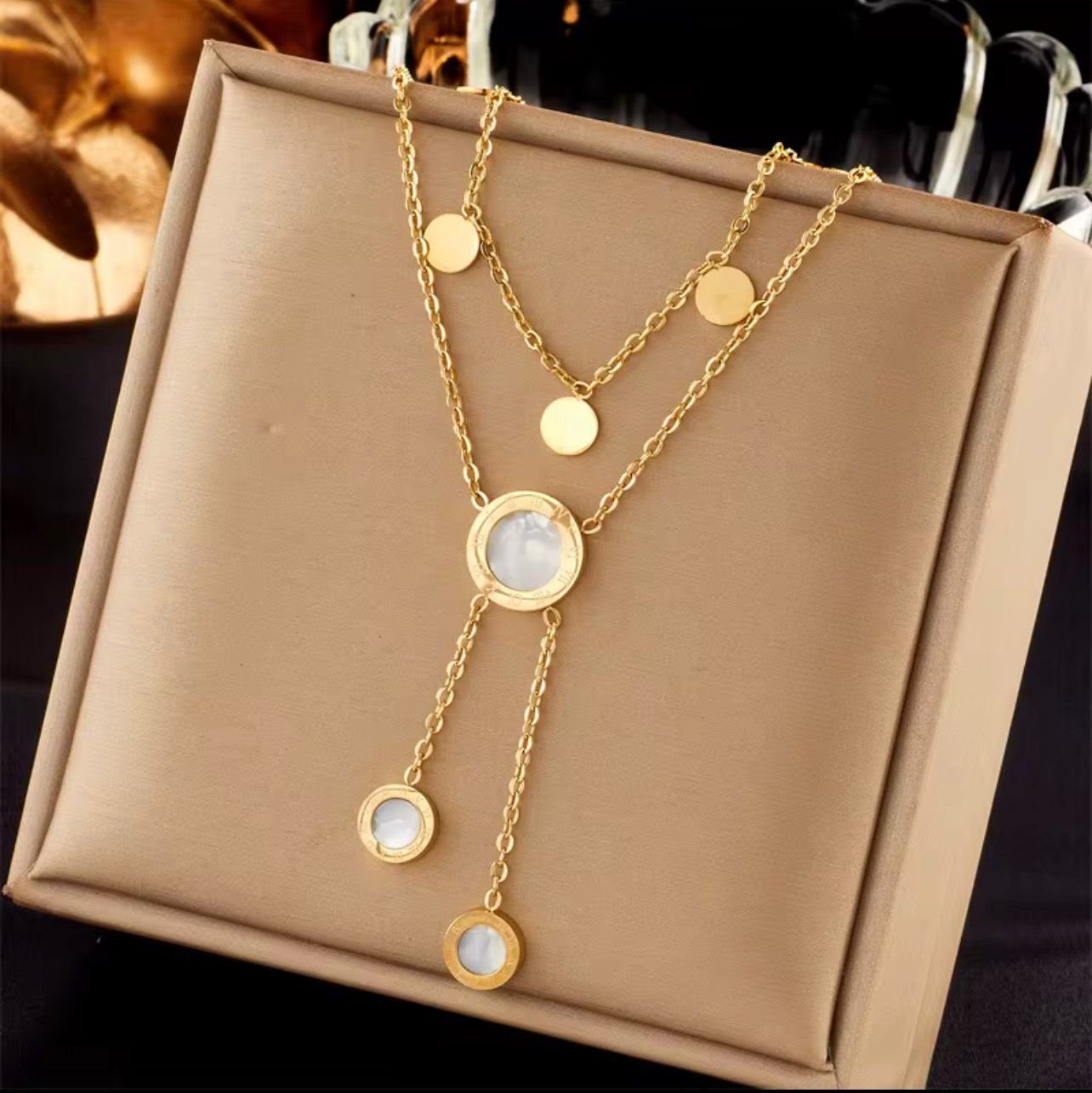 18K Gold-Plated layered necklace featuring multiple round Roman numeral charms and white inlay pendants