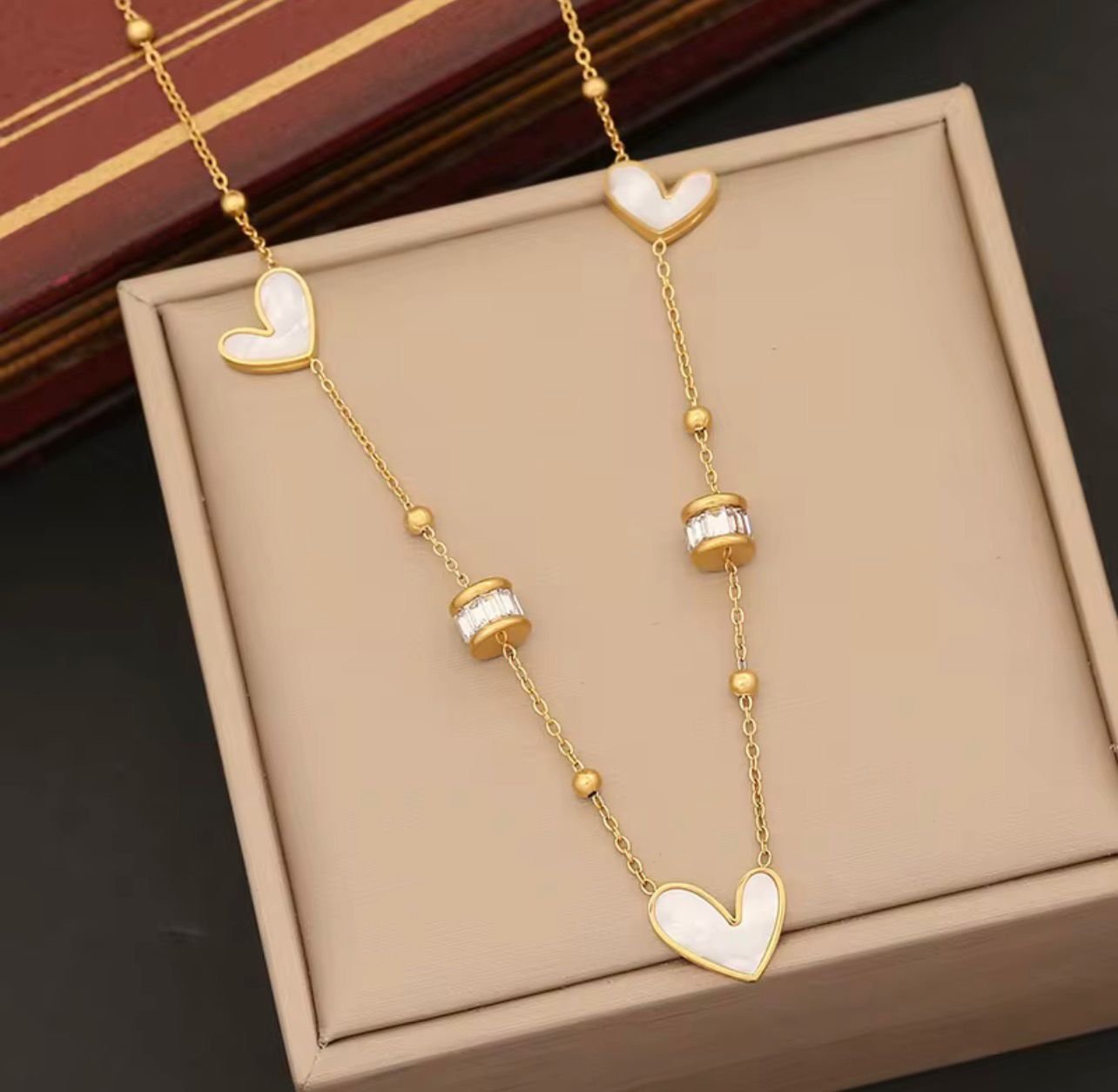 18K Gold-Plated link chain featuring dainty mother-of-pearl heart charms and sparkling baguette-cut Zircon stations