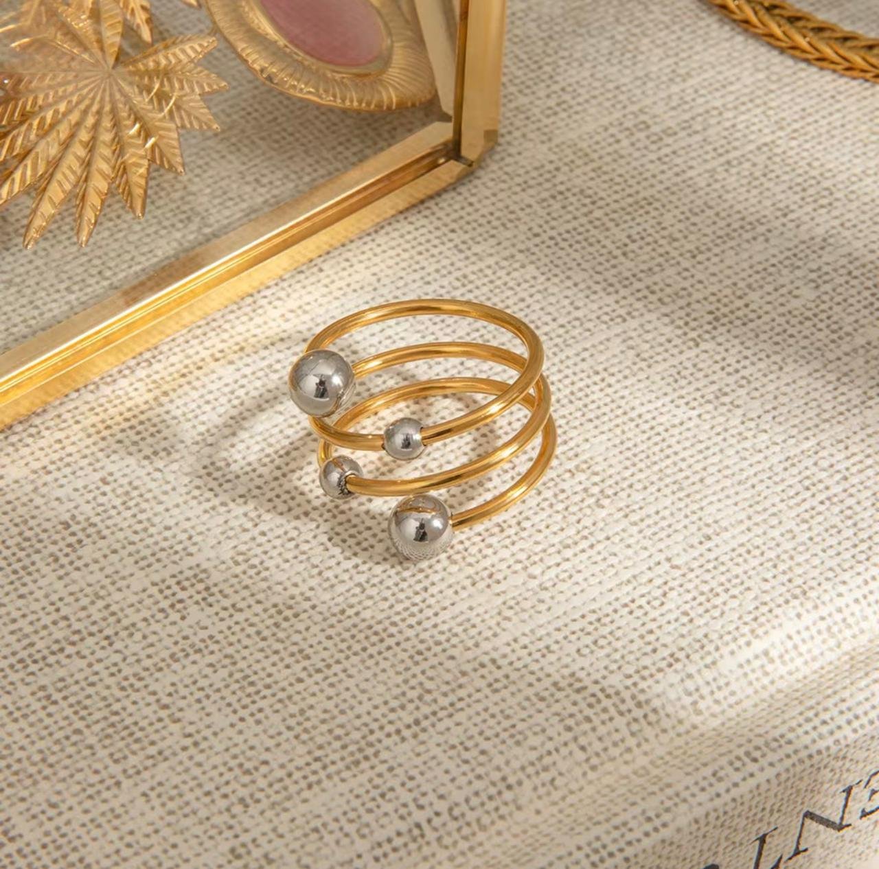 18K Gold-Plated  multi-layer open wrap design that coils around the finger, accented with different-sized metallic spheres