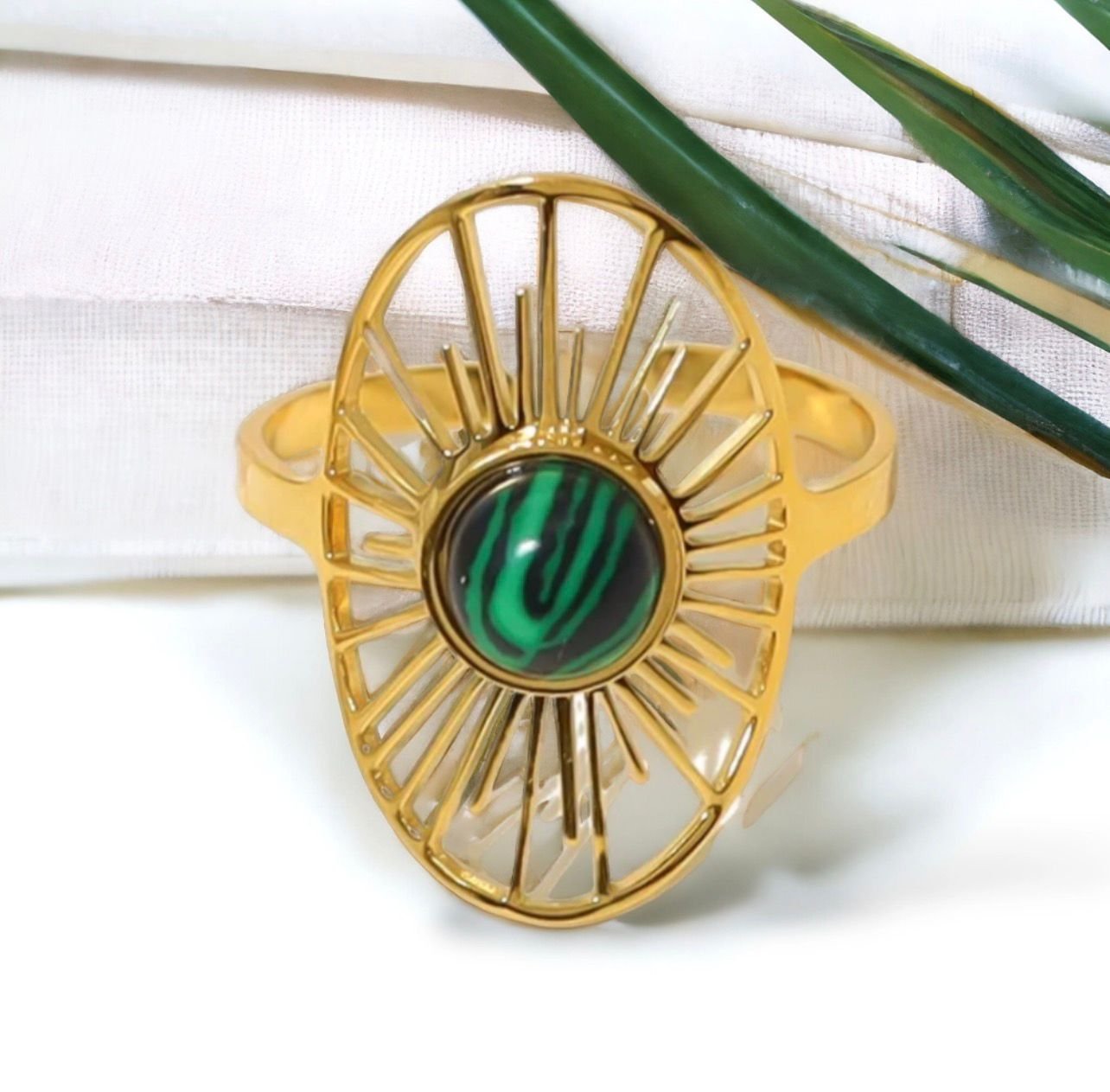 18K Gold-Plated Malachite Sun Ring with a sunburst design framing the natural green stone