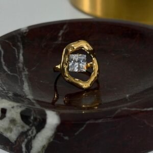 18K Gold-Plated statement piece featuring a radiant square-cut cubic zirconia suspended in a sculptural frame