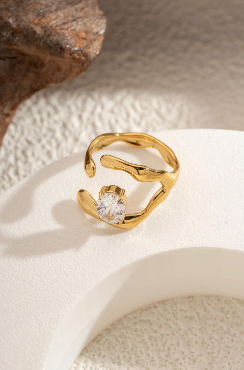 18K Gold-Plated  ring with a center features a square cubic zircon stone set within an irregular, fluid-shaped frame