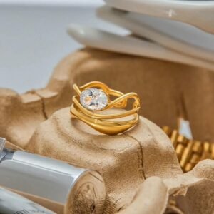 18K Gold-Plated adjustable ring featuring a fluid, openwork band design crowned with a luminous solitaire cubic zircon