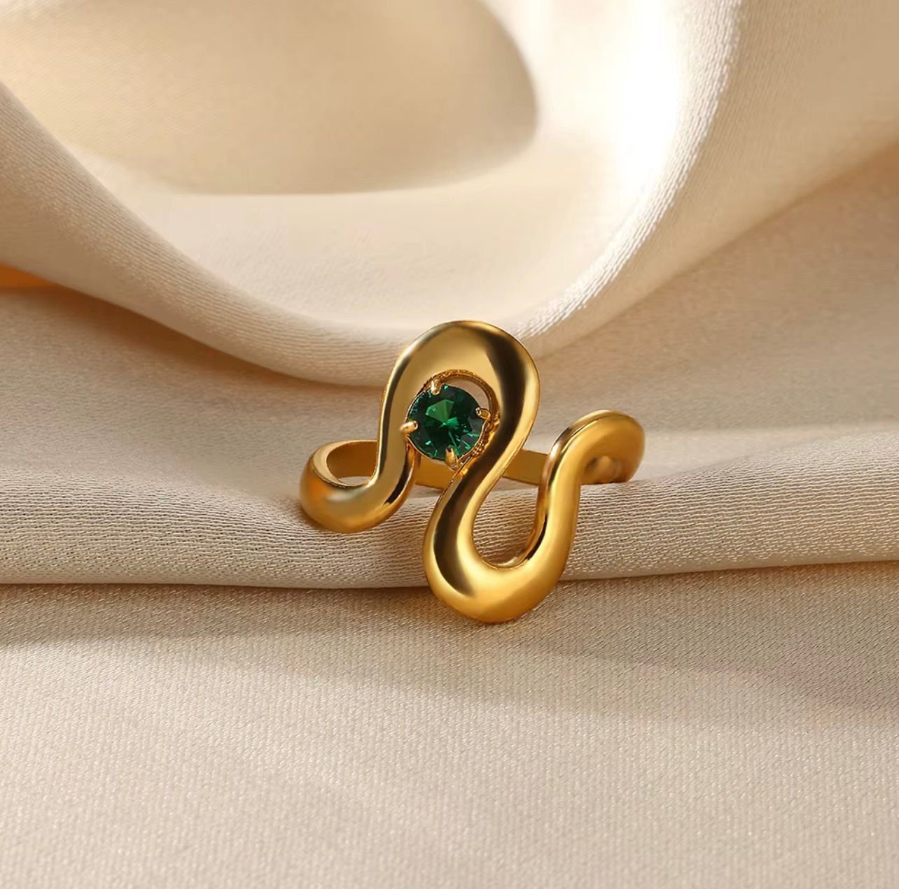 18K Gold-Plated wavy, abstract-style ring features a central green Zircon stone with an adjustable open band
