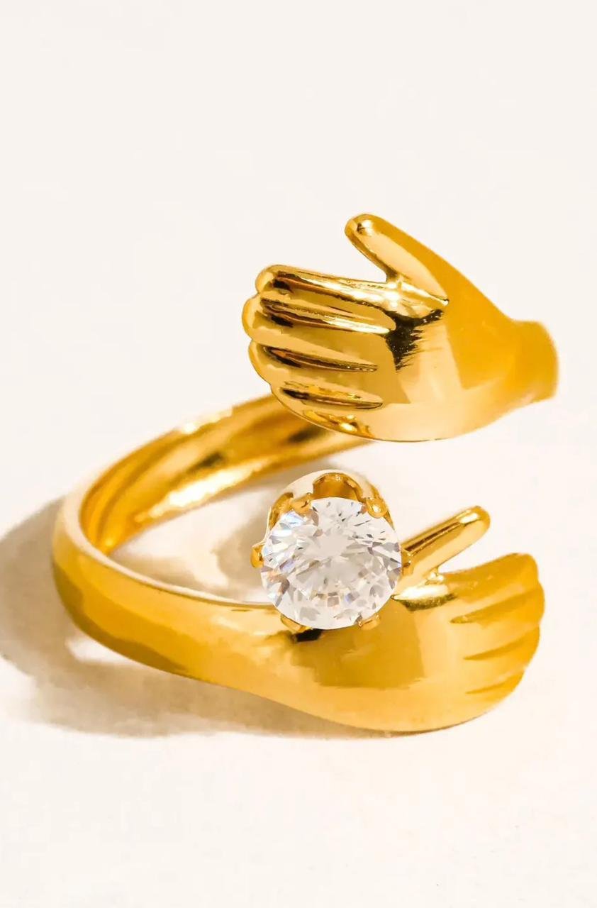 18K Gold-Plated hug ring featuring a zircon stone held by two hands